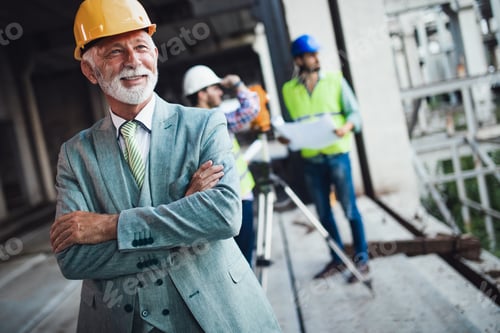 Preview: Team of architects and engineer in group on construciton site check documents and business workflow