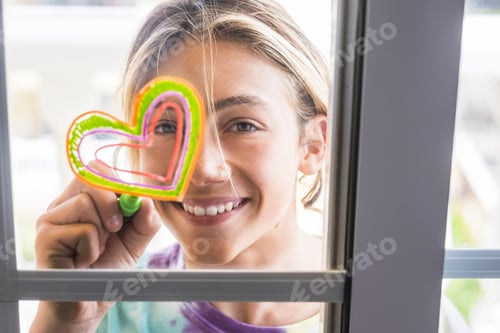 Preview: beautiful young cacuasian boy smile and paint on the glass