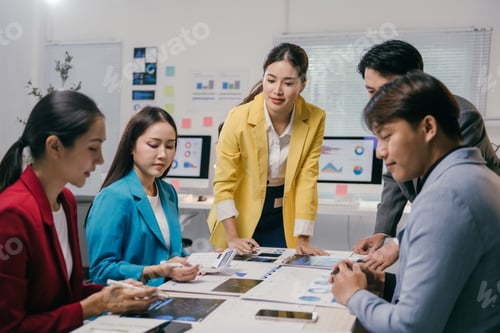 Preview: Group of young asian businesspeople analyzing financial data and discussing business strategy during