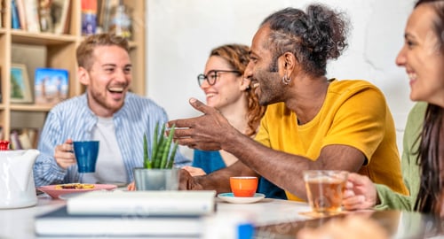 Preview: Happy multiracial friends studying together at library