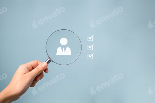 Preview: Hand holding magnifying glass for human resources searching and selecting