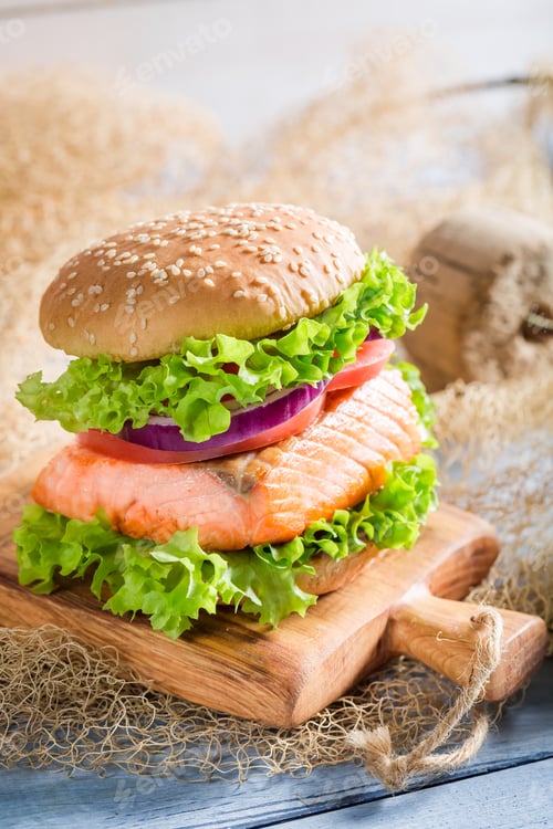 Preview: Delicious fishburger with salmon on old wooden table