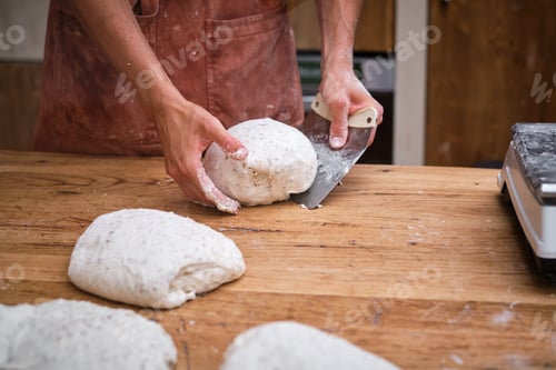 Preview: Photo detail of a baker's hands working the bread dough