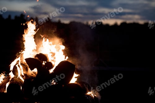 Preview: Silhouette of a campfire at night time