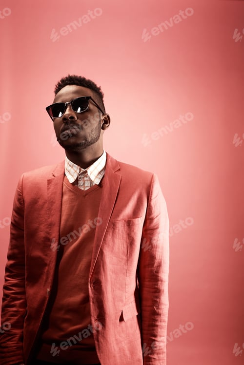 Preview: Portrait of Black Male Hipster in Pink Suit in Studio