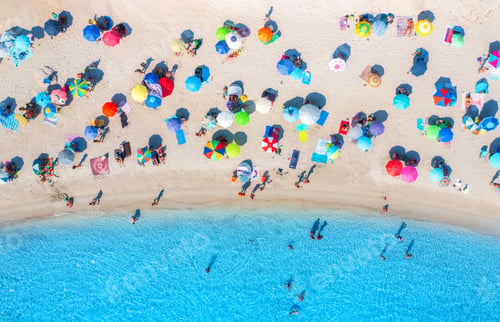 Preview: Aerial view of colorful umbrellas on beach, people in blue sea