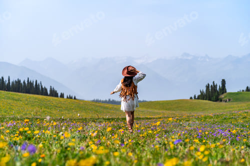 Preview: Young woman traveler relaxing and enjoying beautiful Scenery landscape in Kalajun grassland