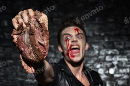 Preview: Brutal crazy man squeezing heart in hand, while screaming