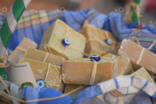 Preview: Discover beautiful handmade organic soap bars presented in a wicker basket with colorful fabrics