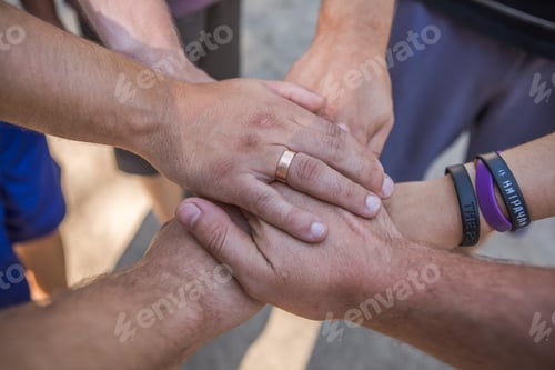 Preview: Close up high angle view of diverse young people putting their hands together - Support, unity and t