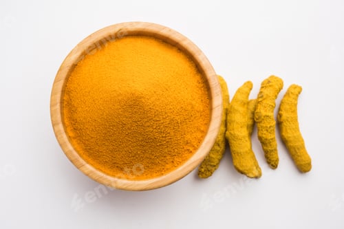 Preview: Organic Haldi or Turmeric powder spice pile in a bowl with whole, selective focus