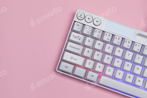 Preview: White keyboard with RGB lighting on pink background, top view. Space for text