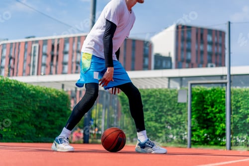 Preview: Tall guy basketball player with the ball shows his dribbling skills during practice