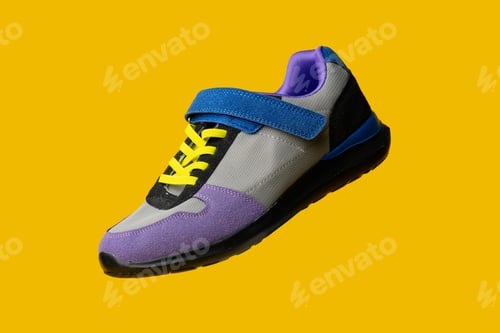 Preview: Violet-blue female sneakers on yellow studio background