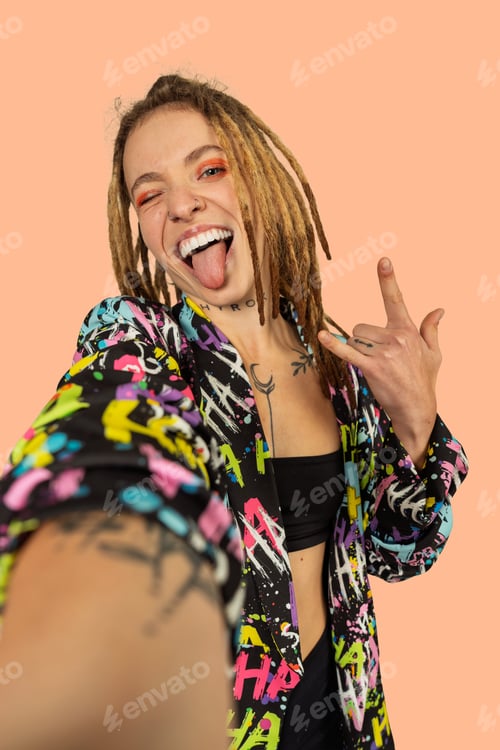 Preview: Young woman with dreadlocks taking fun selfie