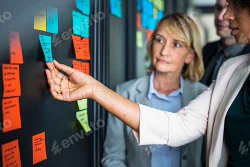 Preview: Businesspeople planning tasks with sticky notes