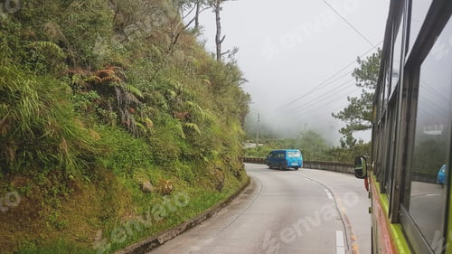 Preview: Scenic Mountain Road with Lush Green Vegetation