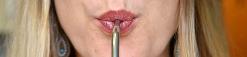 Preview: a lips of young beautiful woman drinks an juice with a reusable metal drinking straw, banner.