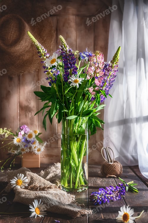 Preview: vase with wildflowers. lupines, daisies, cornflowers