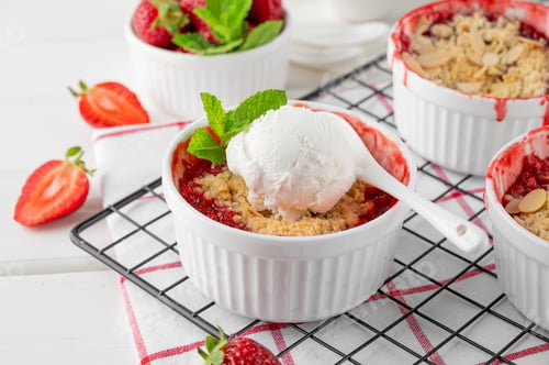 Preview: Rhubarb and strawberry crumble with a scoop of ice cream on top. Top view