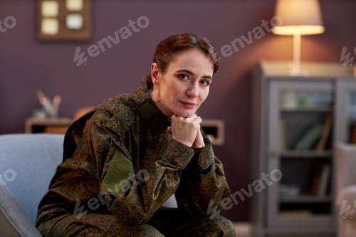 Preview: Young woman wearing military uniform looking at camera