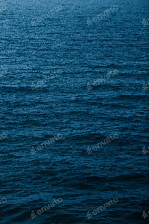 Preview: Vertical shot of water waves on a deep blue sea