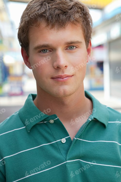 Preview: Young man smiling in a vibrant street setting