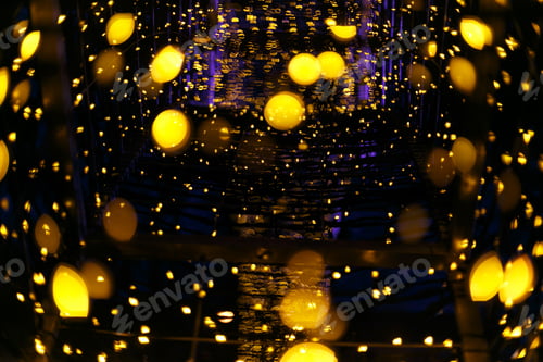 Preview: Christmas Illumination with warm golden lights bokeh in evening. Sparkling glitter