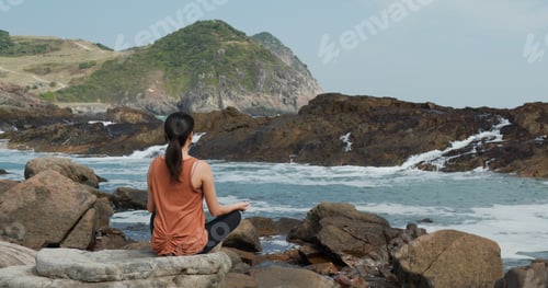 Preview: Woman do yoga beside the sea beach