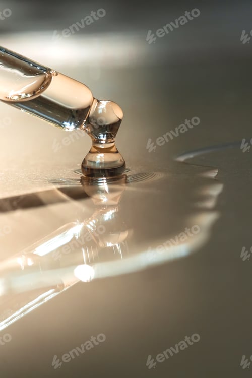 Preview: A Dripping Pipette of cosmetic gel on a beige background.