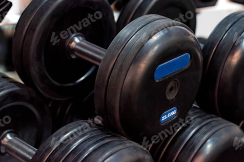 Preview: Closeup image of several black chrome dumbbells