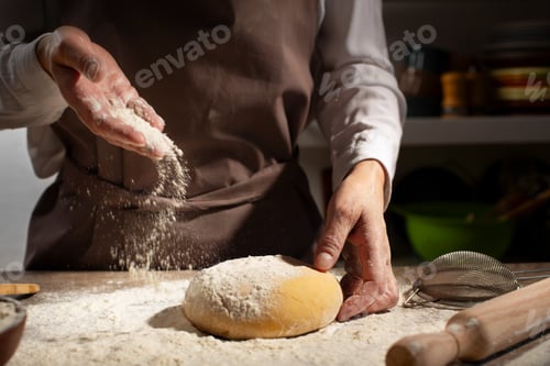 Preview: Baking concept. Caucasian female hands throwing flour at the dough.