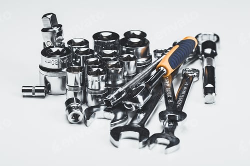 Preview: Collection of various hand tools including sockets, wrenches, and a ratchet set on a white surface