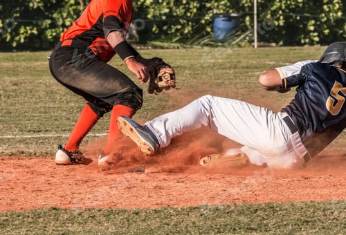 Preview: A high school baseball game where a player is sliding into a base