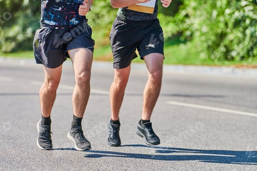 Preview: Athletes running down road, low angle view