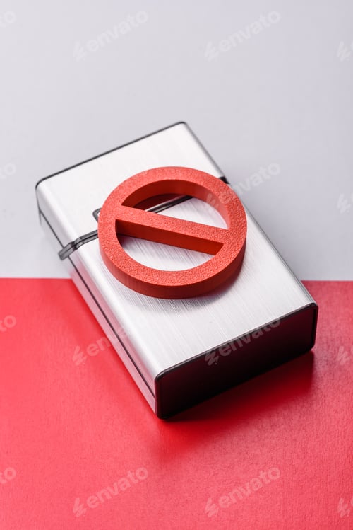 Preview: A metal cigarette box with a no smoking sign depicts a harmful habit. A cigarette box