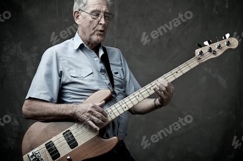 Preview: Senior man playing bass guitar