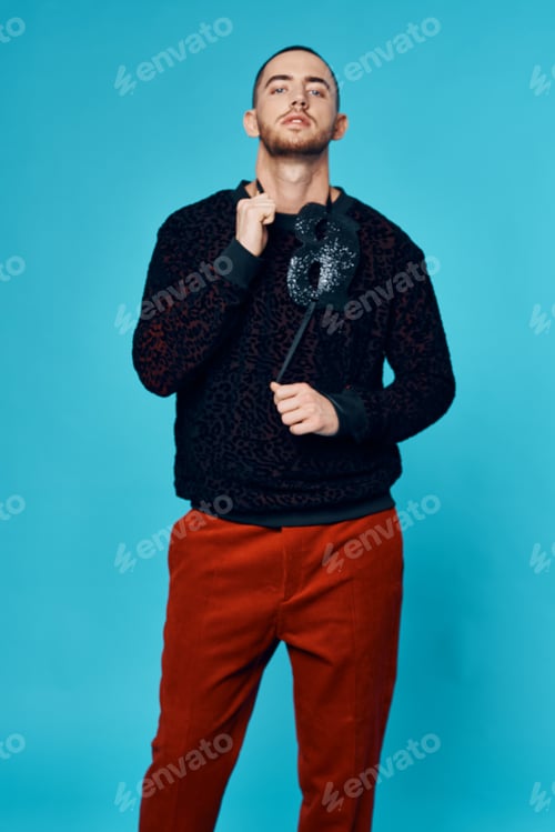 Preview: man in black sweater mask fashion posing blue background