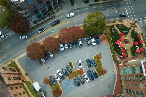 Preview: Aerial view of many colorful cars parked on parking lot on apartment building backyard.