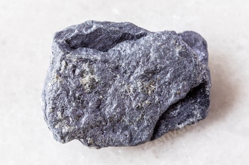 Preview: sample of raw molybdenite mineral on white marble