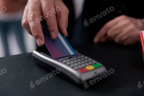 Preview: Elderly client putting credit card on pos terminal paying for pharmaceutics treatment in pharmacy