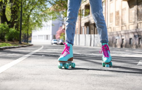 Preview: Woman roller skating outdoors on sunny day, closeup