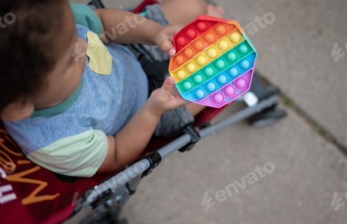 Preview: A toddler playing with a pop it fidget toy