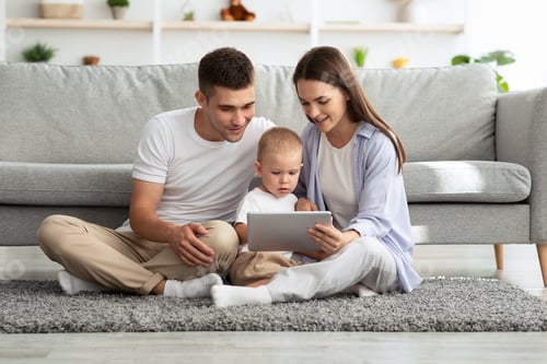 Preview: Family Leisure. Millennial Parents With Toddler Son Using Digital Tablet At Home