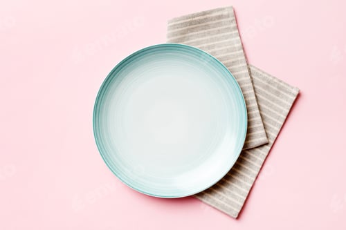 Preview: Top view on colored background empty round blue plate on tablecloth for food
