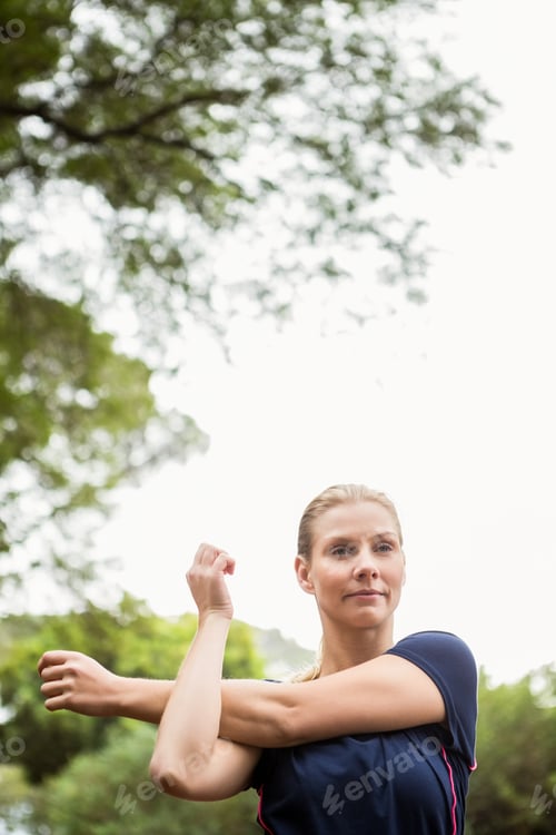 Preview: Serious athletic woman doing arms stretching