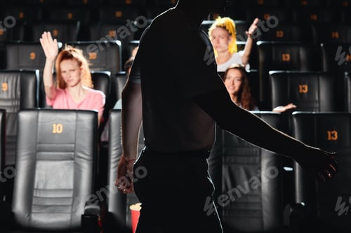 Preview: women scolding a man who is interrupting them to watch a film at the cinema