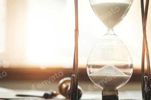 Preview: Wooden desk with vintage sandglass and old letter
