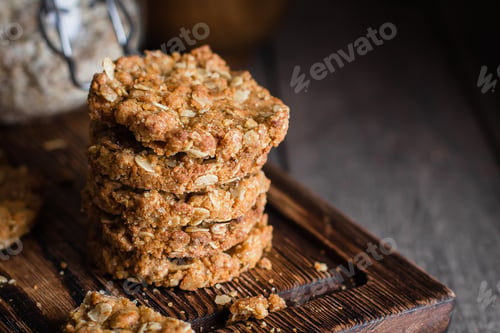 Preview: Homemade oatmeal cookies on wooden board on old table background. Healthy Food Snack Concept.