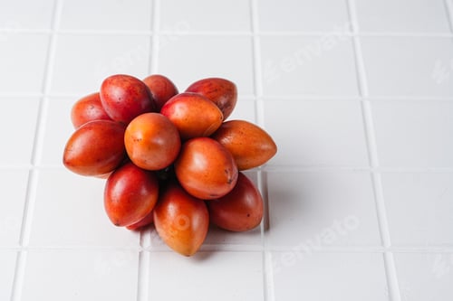 Fresh Tamarillo Fruits on a White Tiled Surface